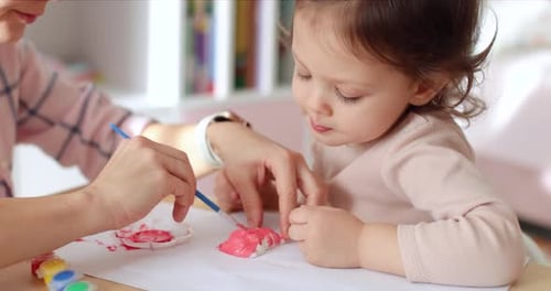 Child and Adult Painting Together