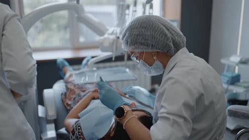 Stomatologist Appointment In Contemporary Clinic Female Doctor Examining Oral Cavity Of Patient