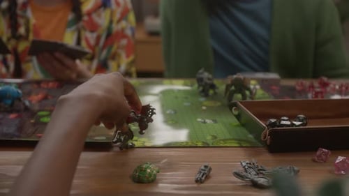 Unrecognizable Woman Adjusting her Mech Figure, Playing RPG Tabletop Game