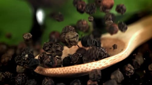 Black Pepper Falls on a Wooden Spoon Filmed on a Highspeed Camera at 1000 Fps