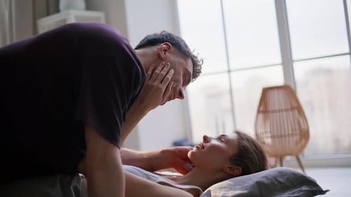 Nahaufnahme, Bettwäsche-Paar, das sich morgens küsst, liegend, weiche Kissen, Frau, Mann, Berühren