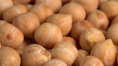 Dry chickpeas or dried garbanzo beans macro rotating background side view. Ingredient for falafel