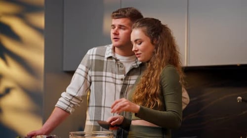 Young Couple Prepares Food Together at Home