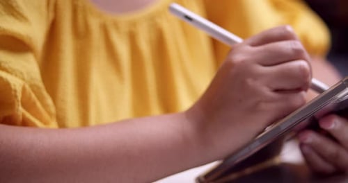 Hands Drawing on Tablet with White Stylus Pen