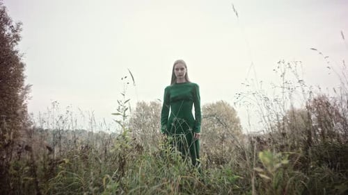 Model posing in green dress for fashion photoshoot