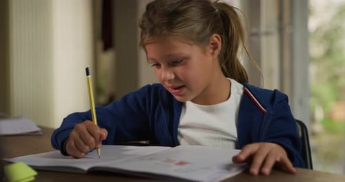 Cute Girl Drawing and Smiling Indoors