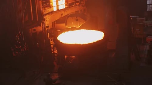 Witness the Intense and Mesmerizing Molten Metal Pouring Process Occurring in a Foundry Setting