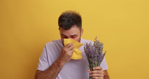 Man with lavender bouquet looking unwell