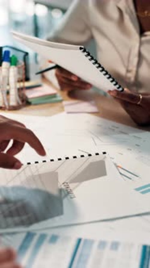Professionals Discussing Financial Report in Workplace