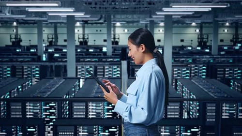 Side View Of Asian Business Woman Using Tablet In Data Center