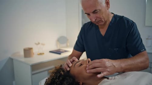 Closeup Osteopath Massaging Head in Ward Mature Physiotherapist Healing Woman