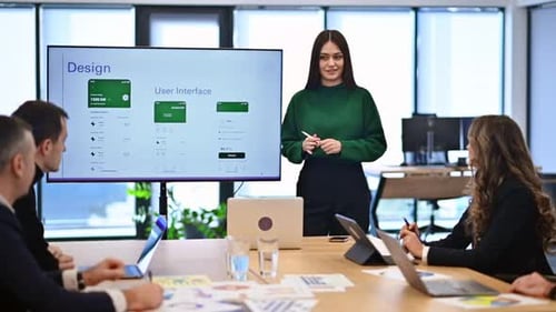 Female worker leading business meeting in an office, discussing business affairs with other workers