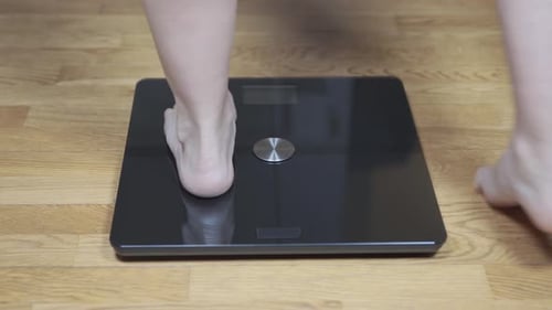 Bare Feet Standing on a Digital Scale