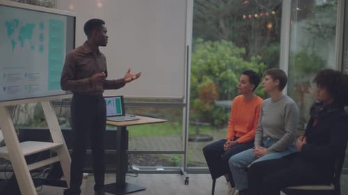 african american businessman giving workshop training to young colleagues indoors