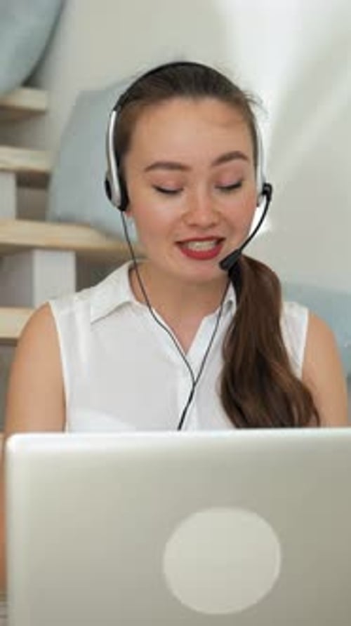 Smiling Young Adult with Laptop and Headset