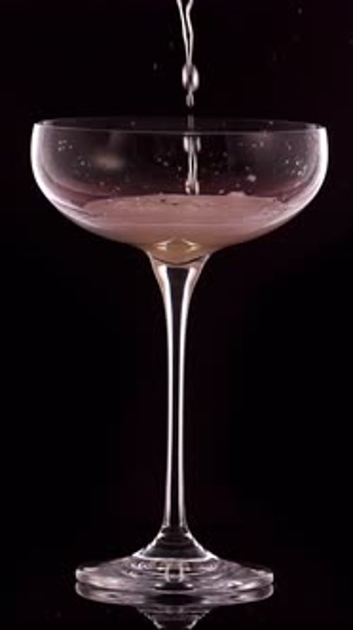 Champagne Pouring into Elegant Glass on Black