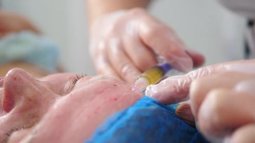 Woman Receiving Injection In Face During Medical Procedure