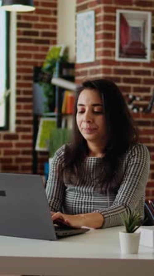 Young Woman Working on Laptop at Home
