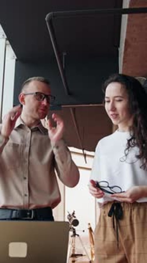 Office employees discussing the project on the laptop.