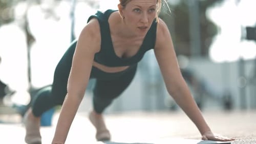 Woman Doing Push-Ups in Urban Outdoor Setting