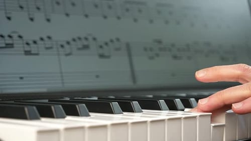 Close up of Hands Playing Piano Keys