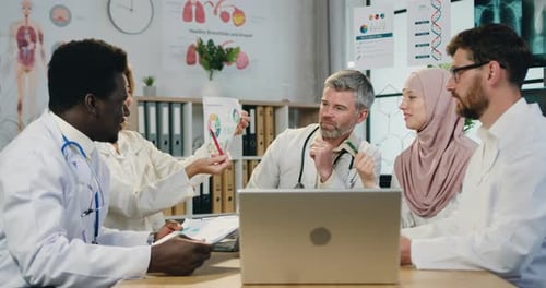 Diverse Medical Team Collaborates on Project in Office