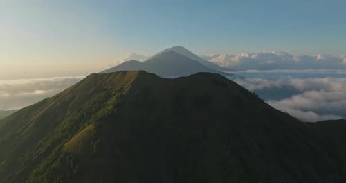 Sunrise view of grand mount Batur in Bali with Abang and Agung in background