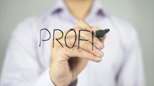 Adult Writes the Word 'Profit' on Glass