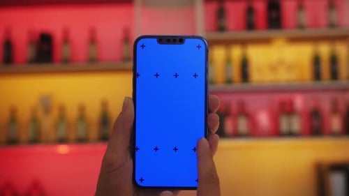 Customer at the Bar Cafe Restaurant Holding Smartphone with Blue Screen Chroma Key Watching Digital
