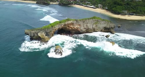 Drone view of coral rock crushing by the wave on the tropical beach