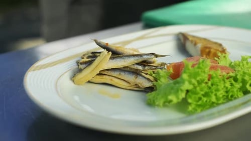 Chef preparing fish plate in restaurant kitchen. slow motion,close up. 4K