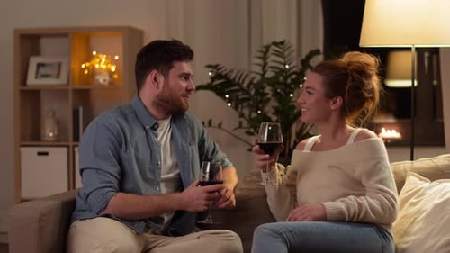 Couple Relaxing and Drinking Wine Together at Home