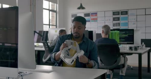 Engineer with VR headset testing VR Technology in an Office
