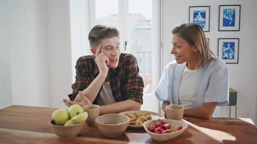 Young Adults Talking Over Breakfast at Table