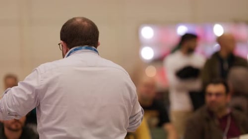 Speaker Presents to Seated Audience at Corporate Conference