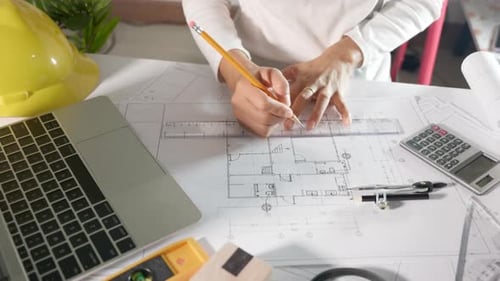 Architect Typing Laptop Keyboard to Design of House Before Editing Drawing with Ruler on Blueprint
