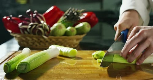 Professional chef preparing white onion for cooking
