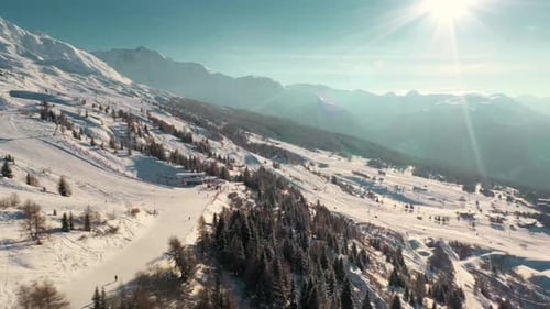 Beautiful ski resort slopes on snowy mountainside, sunny aerial view