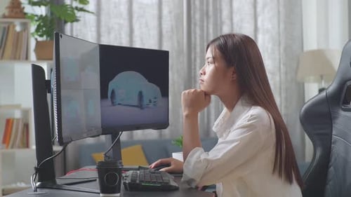 Side View Of Asian Female Designer Thinking Of Idea While Working On 3D Model Of Ev Car On Computer