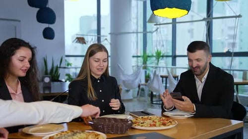 Business People Enjoying Pizza Lunch at Modern Workplace