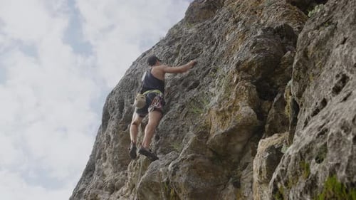Athlete Engages in Climbing Session on Mountain in Summer