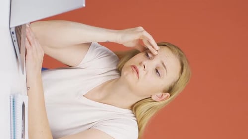 Woman Suffering From Headache While Working On Laptop