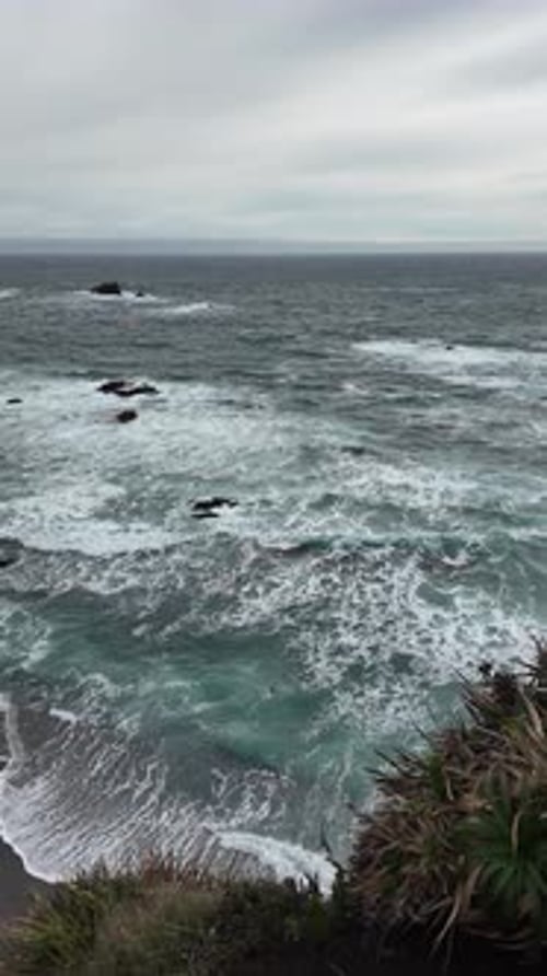 Ocean Waves Crashing on Rocky Shoreline at Sunset