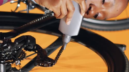 Vertical Video Expert Applying Adhesive on Bike Parts During Checkup Process Close Up Shot
