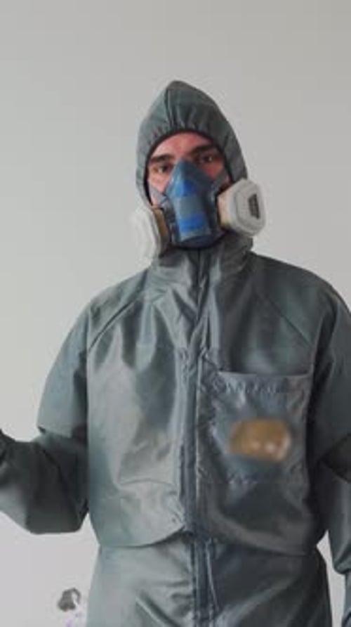 Person in Protective Suit Gives Thumbs Up