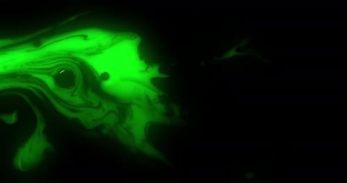Neon Green Paint Flowing To The Left Against Dark Background