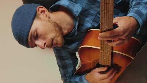 Man Plays Guitar Indoors