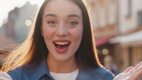 Young Woman Looking Surprised at Camera Shocked By Sudden Win Good Victory News Wow in City Street