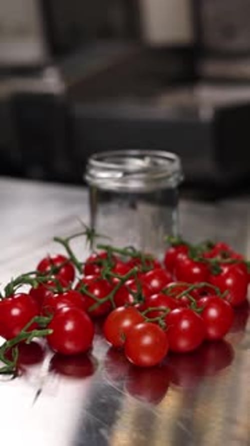 The chef preserves vegetables in the kitchen. Close-up