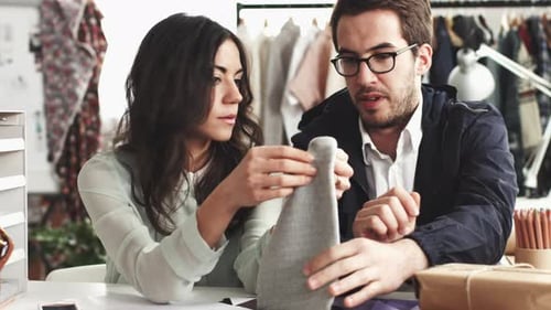 4k video footage of two designers swatching fabrics for their new collection